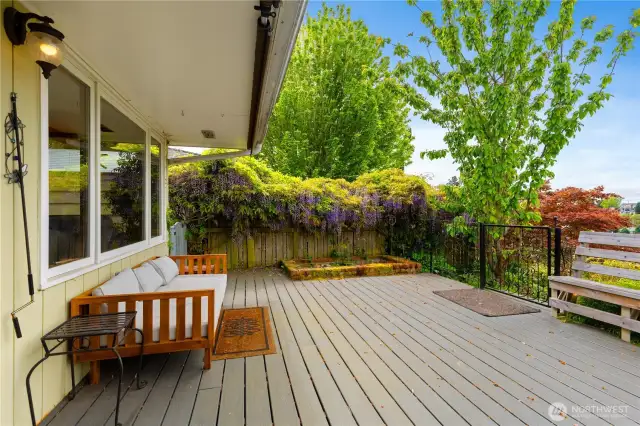 Another view of this large front trext deck surrounded by beautiful landscaping with stunning water mountain and city views to enjoy year around