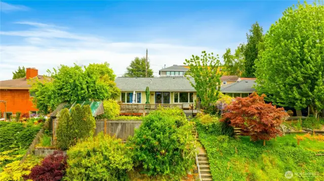 Welcoming front entry with colorful landscaping lots of and newer roof great you when you make this your next home.  The roof top will get you even more views of Seattle waterfront and sunrises