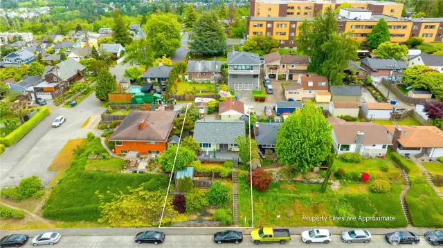 Aerial front view of this home on large lot with front elevated garden space to view yr around.  Lots of extra street parking also.