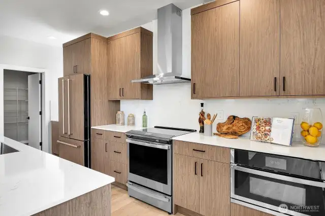 The kitchen also features stainless appliances, soft close cabinetry and a large walk in pantry!
