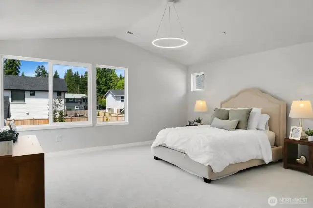 Retreat to the huge, vaulted primary suite, complete with oversized windows and a serene backyard view.