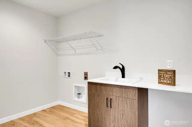 Spacious laundry with utility sink on the upper level.