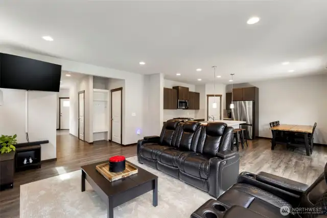 Open living space leads to dining room and kitchen area with island bar