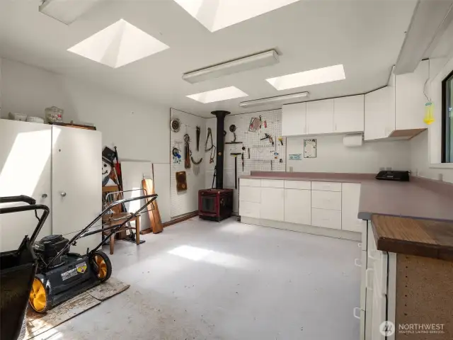 Fantastic shop space with wood stove and skylights.