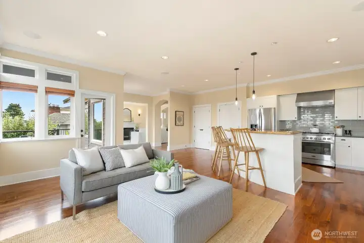 Note the door to the deck off to the left. Kitchen with many newer appliances to the right. The doors near the kitchen are for the pantry. Tons of storage! In front of the pantry doors is a perfect spot for a round dining table.