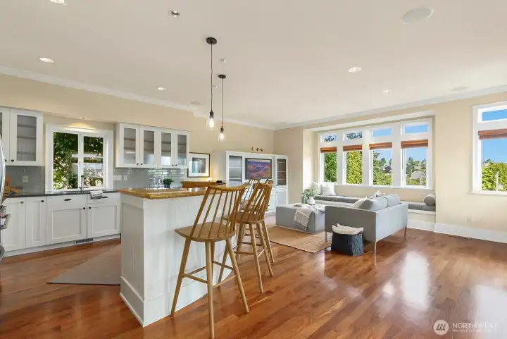 Back inside, another view of the kitchen. Cabinets galore and the island has tons of seating!