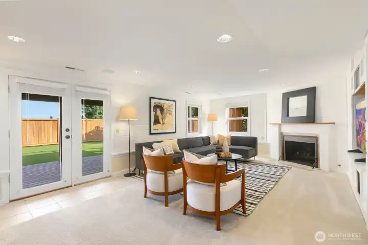 Heading to the lower level, you'll find the walk-out, daylight rec room! This room is adorable and provides access to the backyard via the outdoor living space under the waterproof deck above.