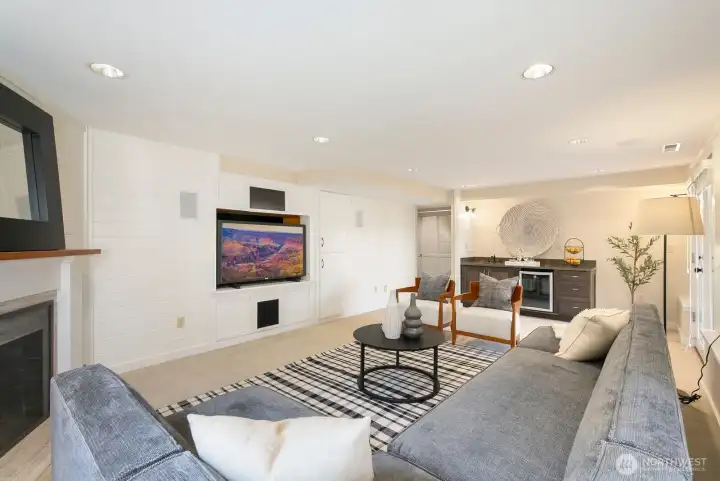 The gas fireplace is on the left and the wet bar is also pictured here. Head outside all year long for indoor/outdoor living!