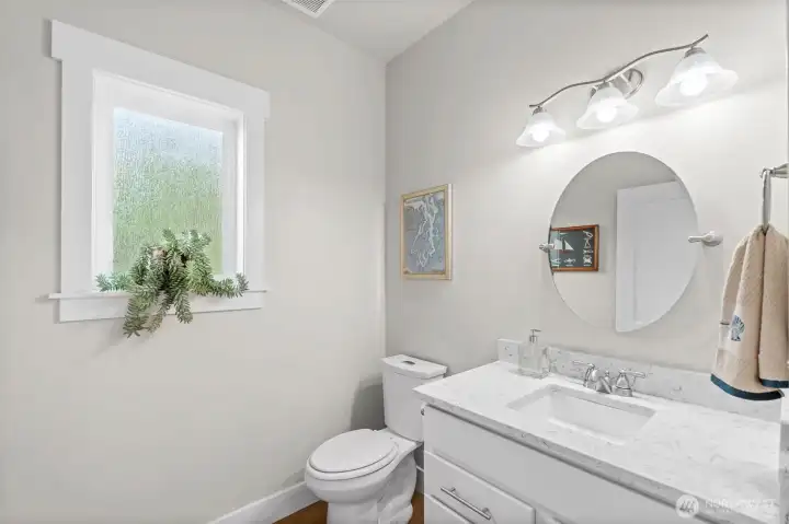 Just off the kitchen you will find a conveniently located powder room