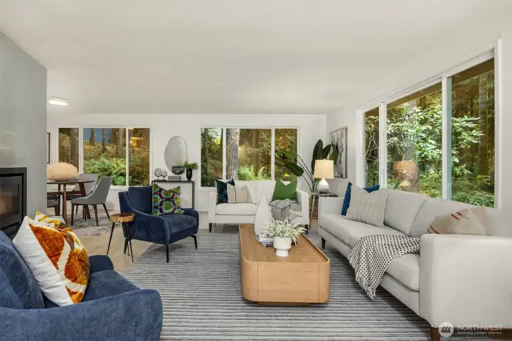 Relax in the living room with tranquil views of evergreens and natural beauty.
