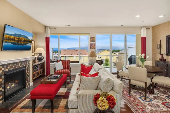Living room area with Cascade Mountain view and cozy gas fireplace.
