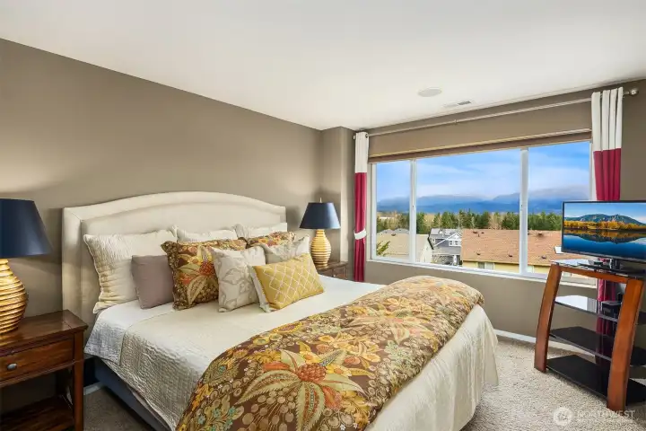 Mountain views continue into the primary bedroom suite.