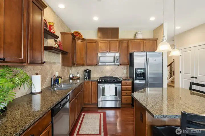 Slab granite surfaces and tile backsplash.