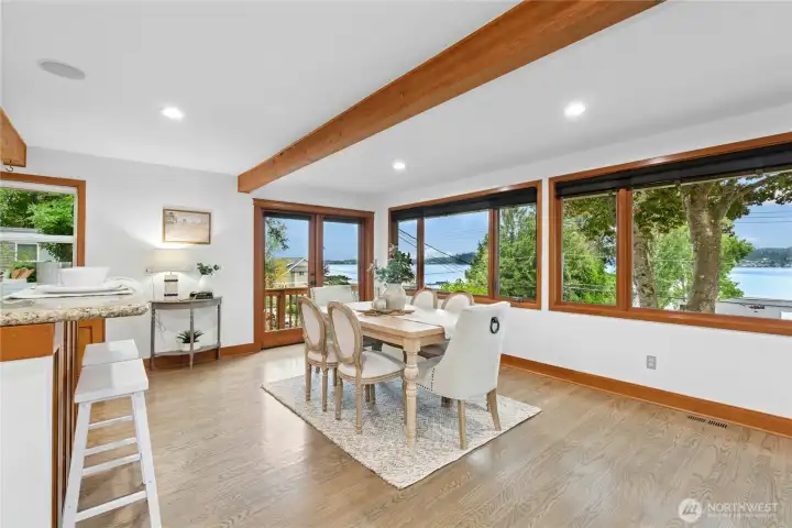 Walls of windows and expansive view decks on both levels invite the outdoors in, creating a seamless connection to the beautifully landscaped grounds with fruit trees and ever-changing lake vistas.