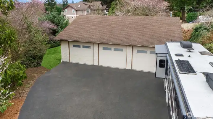 Detached, 2400 SF, 6-Car garage with additional room for RV parking. The garage has 3 over-height garage bays, each 2 car lengths deep.