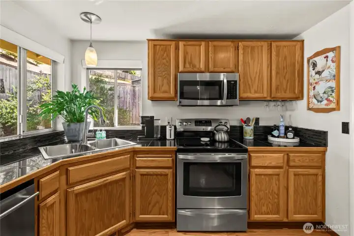 Glass tile backsplash and updated pendants complete the contemporary look.