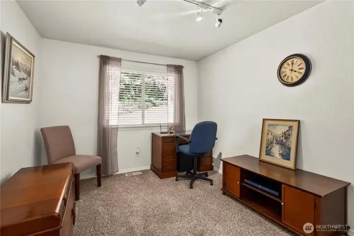 Bedroom 3 has a lovely view of the back yard and a Walk in Closet
