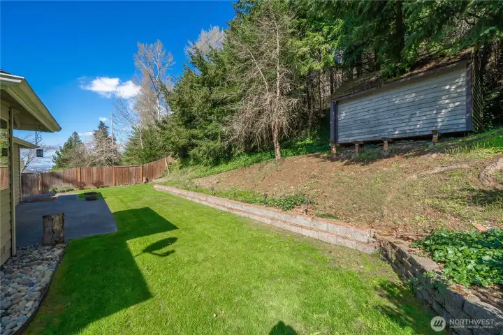 Roomy backyard is fully landscaped.  Shed stays!