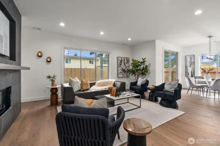 Light-filled open great room with modern fireplace.