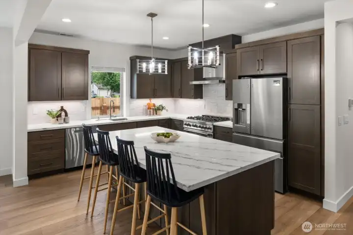 Chef’s kitchen with oversized island and quartz counters.
