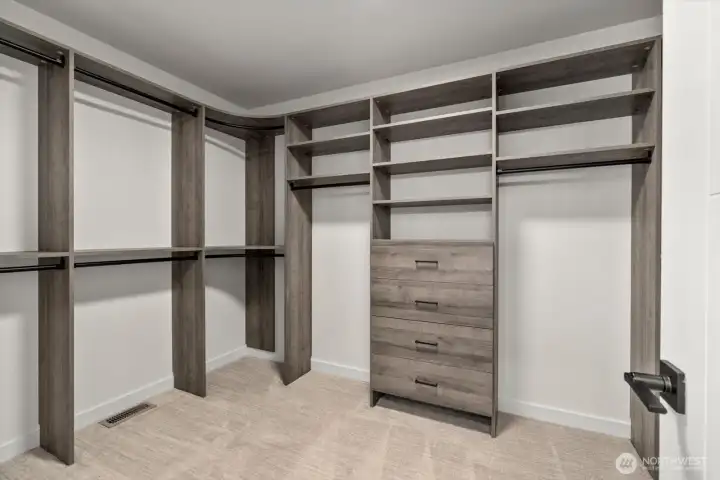 Oversized walk-in closet with custom closets and drawers for great organization.