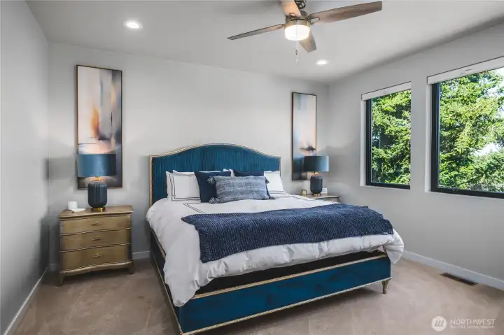 Primary bedroom with large windows.