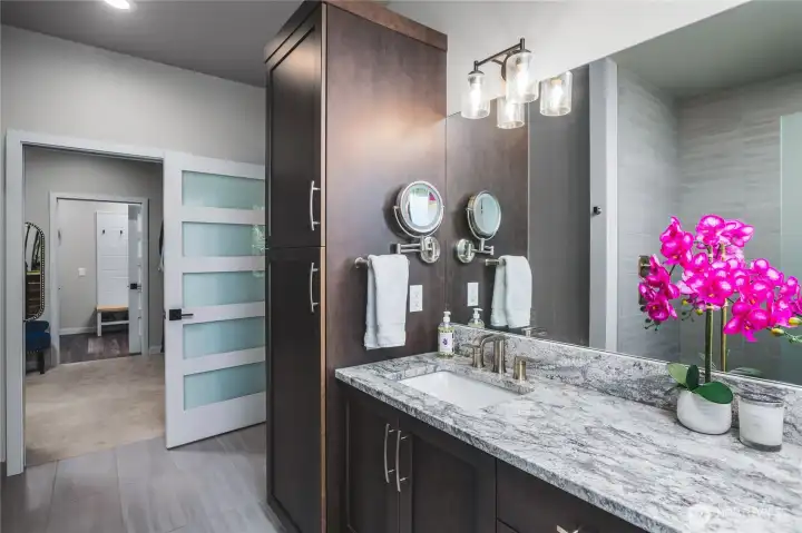 Primary ensuite with double vanities and custom cabinetry.