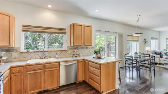 Kitchen offers open sight lines to the eating space and living room with views to the back yard and scenic gardens.