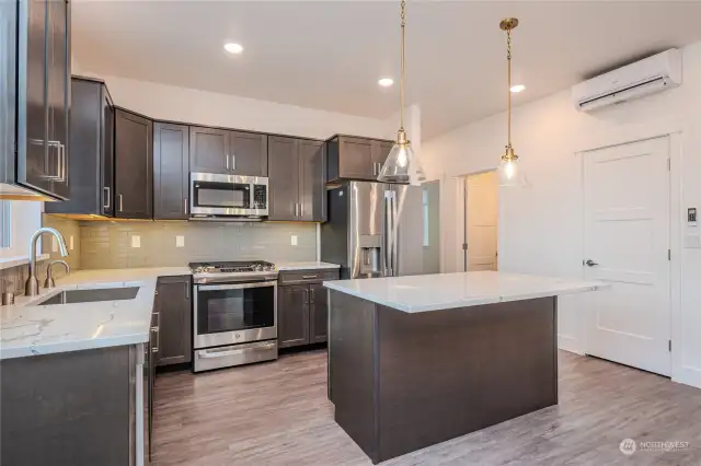 Thoughtfully designed with a modern flair, this kitchen features abundant quality cabinetry, a stainless steel, single large basin sink and garbage disposal and energy efficient appliances. Little things can go a long way, like eliminating the visibility of the microwave venting for a more clean & usable space.