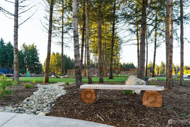 The neighborhood boasts a fenced Dog Park, providing a safe and designated area for residents' furry companions to play and socialize off-leash. Wooden benches found throughout the Park provide a tranquil place to relax and enjoy the serene surroundings.