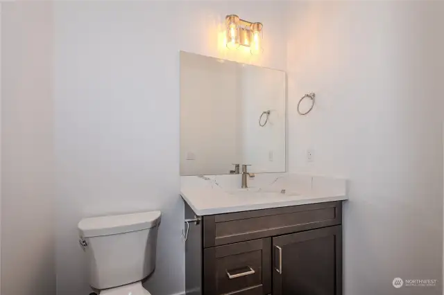 The convenient main floor Half Bathroom features an attractive vanity with quartz counter.