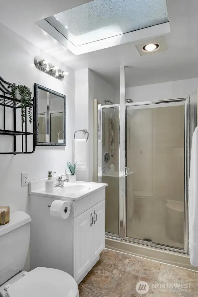 Private ¾ primary bath with skylight and walk-in shower.