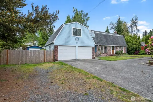 Front of home, extra parking & RV parking behind fence.
