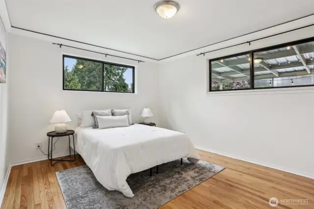 Primary bedroom with views to the backyard.