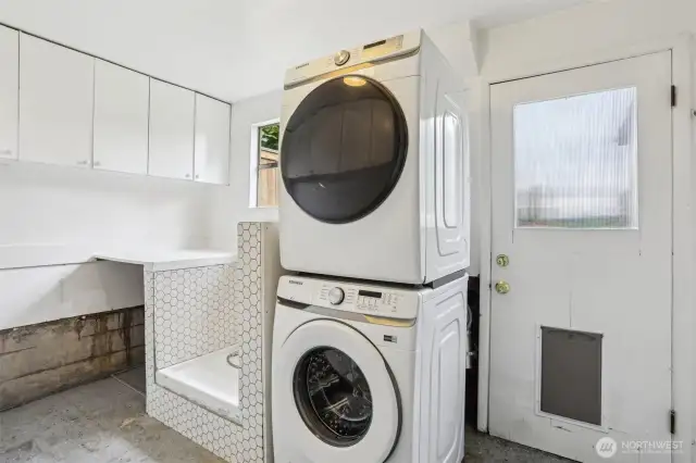 Washer and dryer tucked conveniently in the garage. Dog wash station to boot!