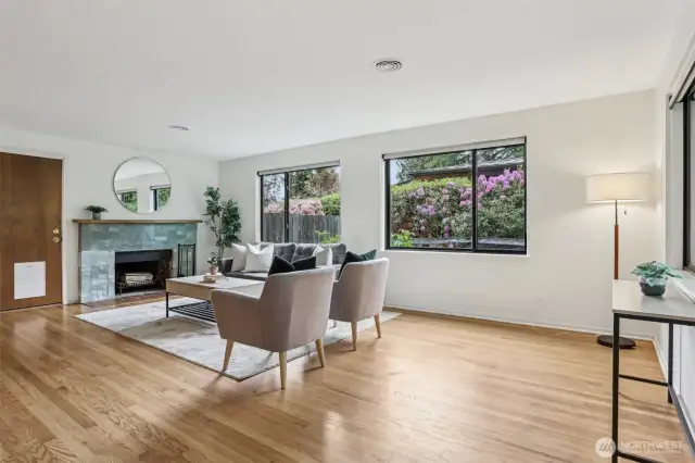 Main entry to spacious living room with wood burning fireplace.