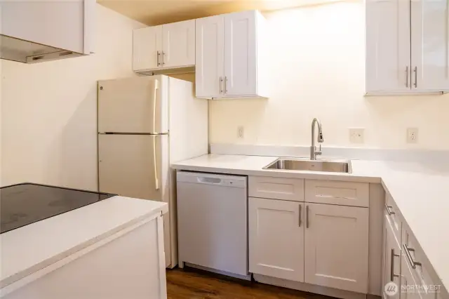 Unit 1 along with all the other 3 units feature kitchens w/ dishwasher, refrigerator and oven.