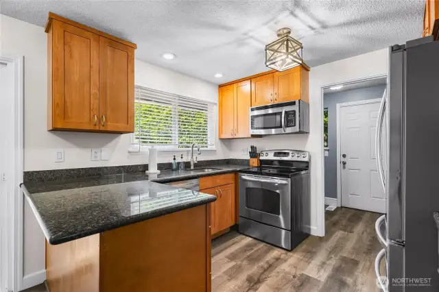 Kitchen with eating space and natural light featuring stainless steel appliances