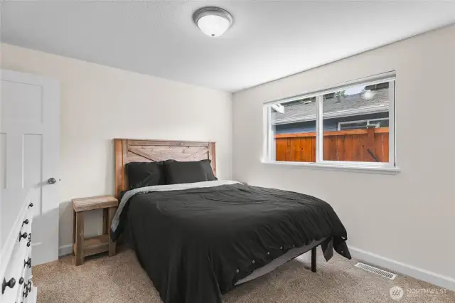 Primary Bedroom with natural light and fresh paint. Private 3/4 bathroom attached