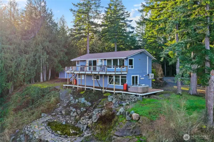 Tucked among towering evergreens, this serene retreat offers elevated forest views, expansive decks with a hot tub, and a peaceful sense of privacy that feels worlds away while still close to town.