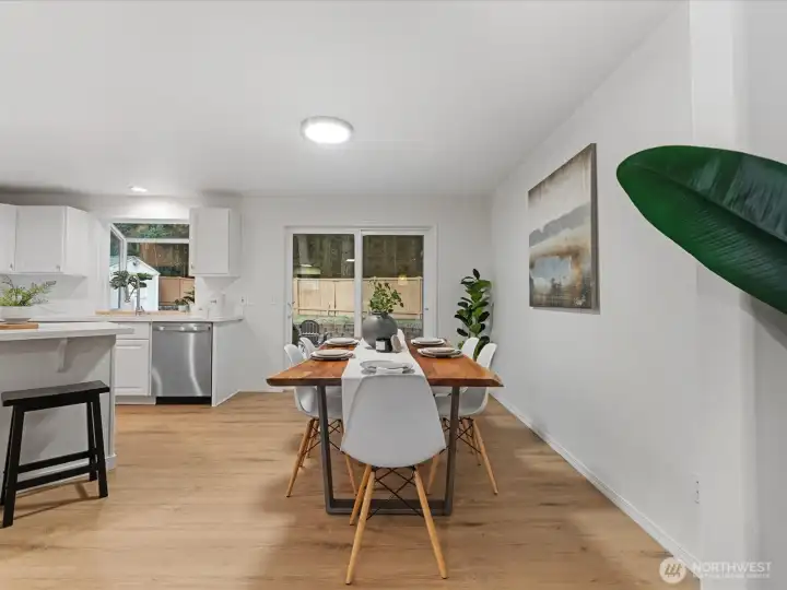 Open dining areas with seamless flow to the kitchen and new sliding door access to the backyard for easy indoor-outdoor living