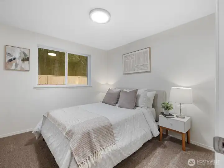 Spacious Bedroom 1 with fresh paint and carpet