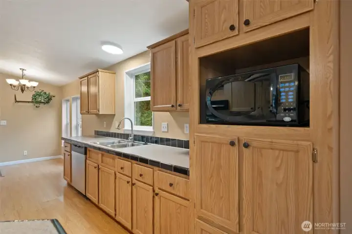 Gally Kitchen with serving or breakfast bar. Adjacent to dining room and a flex room. Walk-in pantry and laundry are adjacent the flex room in this photo.