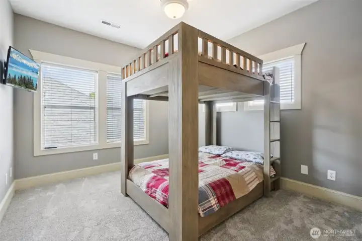 Bright secondary bedroom offering flexible use, featuring ample natural light, soft neutral finishes, and a layout well suited for guests, children, or home office needs. Comfortable proportions allow for a variety of furniture configurations.