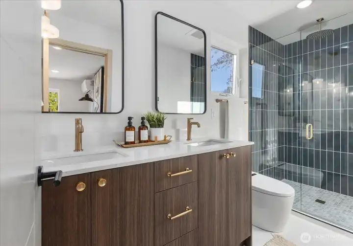 Ensuite bathroom with dual vanities and rainfall shower.