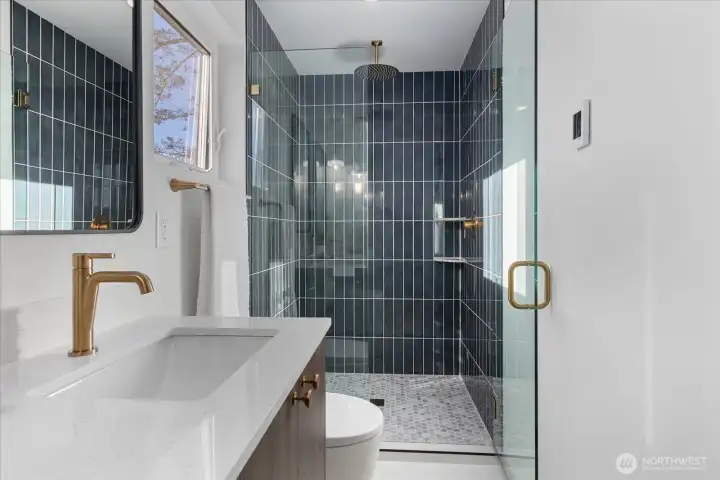 Spectacular walk-in shower with floor to ceiling tiling.