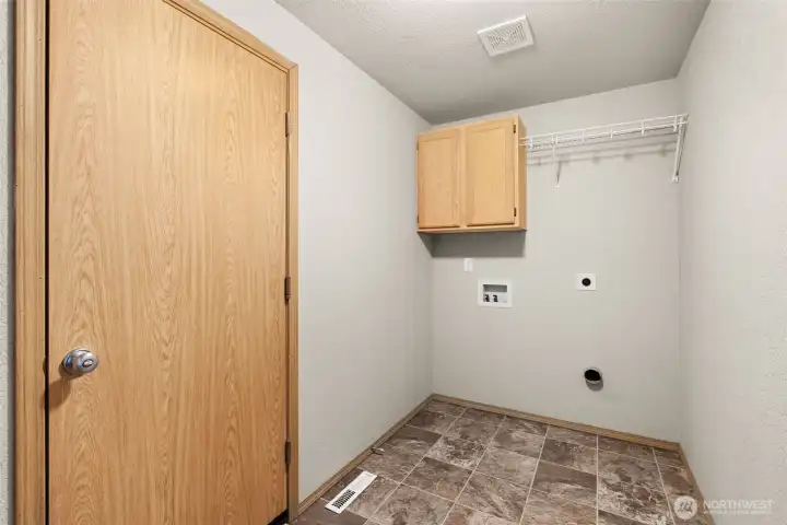 Large laundry room on lower level with pass through to garage.