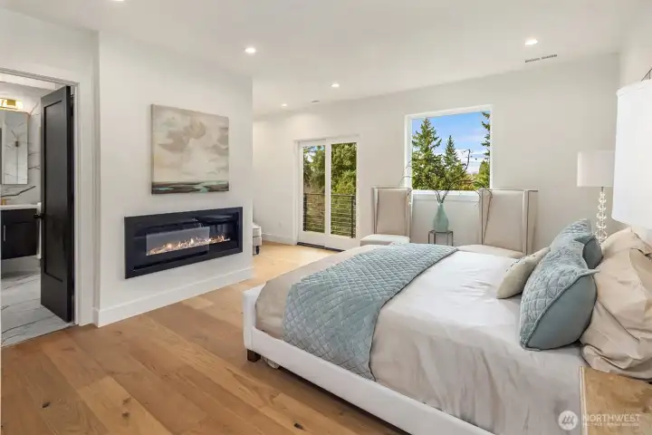 Truly luxurious primary suite with fireplace and private patio access
