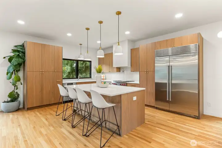 Plenty of space to host and entertain around this island! Notice the pot pull above the range?