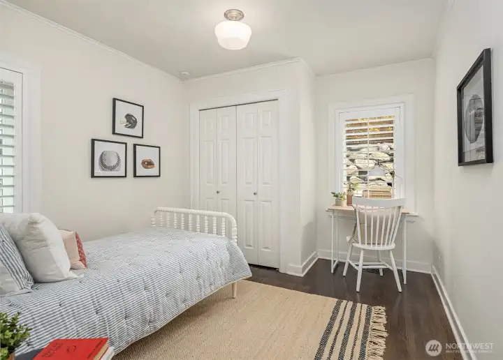 Main level bedroom 2 overlooks the backyard